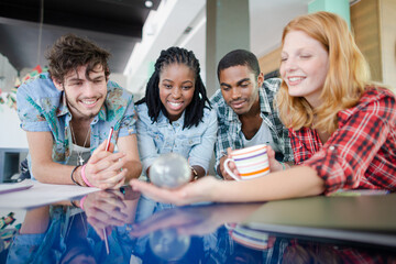 People examining miniature globe