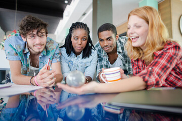 People examining miniature globe