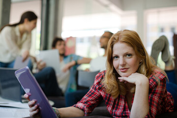 Woman using digital tablet in cafe