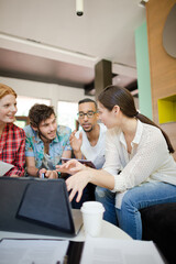 People working at laptop in office