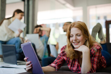 Woman using digital tablet in cafe