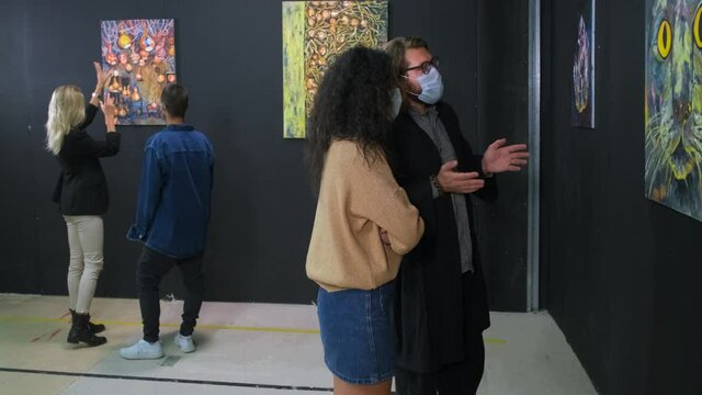 young people are visiting museum at pandemic of Covid-19, wearing face masks