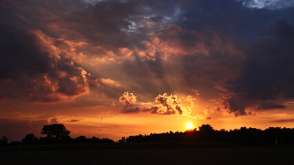 A dramatic sky with clouds during the sunset.