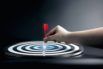 Fototapeta na wymiar concept of bullseye is the goal of the business. Hands place the darts on the target board. Strategic Planning and Goal Setting for Business Success