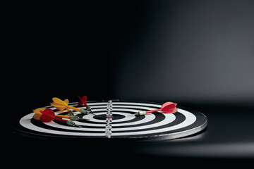 concept of bullseye is the goal of the business. darts, target board on 
black background with copy space
