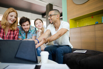 People working at laptop in office