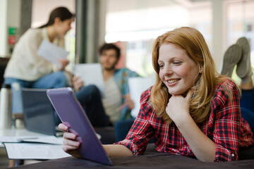 Woman using digital tablet in cafe