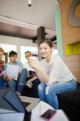 Woman drinking coffee in office
