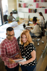 People reading folders in office