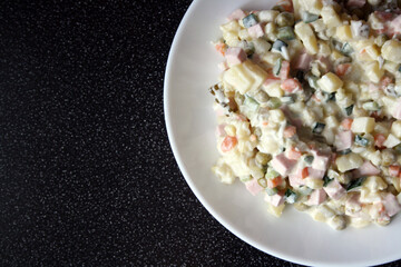 Salad of potatoes, sausage, peas, carrots and cucumbers. Olivier.