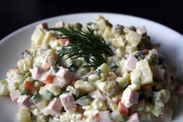 Salad of potatoes, sausage, peas, carrots and cucumbers. Olivier.