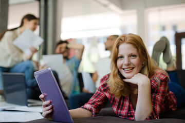 Woman using digital tablet in cafe