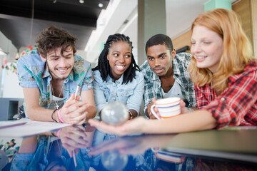 People examining miniature globe