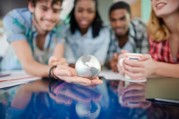 People examining miniature globe