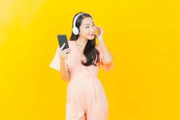 Portrait beautiful young asian woman with headphone and smart phone for listen music