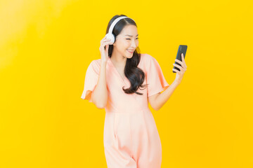 Portrait beautiful young asian woman with headphone and smart phone for listen music