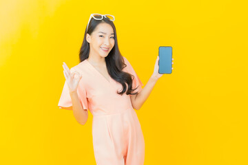 Portrait beautiful young asian woman smile with smart mobile phone