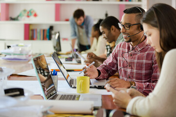 People working at conference table in office