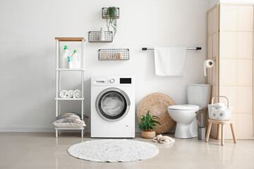 Interior of bathroom with modern washing machine