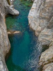 Verzasca Riverbed with  clear emerald green water in Canyon with clear turquoise water