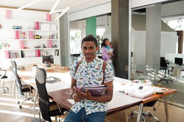 Man sitting on desk in office