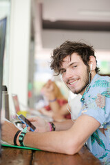 Man listening to mp3 player in cafe