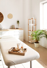 Tray with beautiful spa composition on couch in salon
