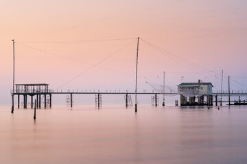 Fototapeta premium Minimalist view of fishing huts at sunrise