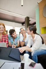 People working at laptop in office