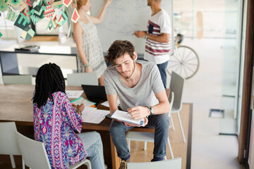 Man taking notes in meeting