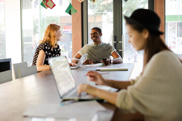 People working at conference table in office