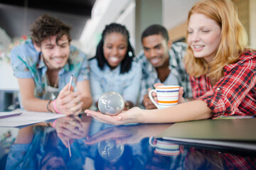 People examining miniature globe