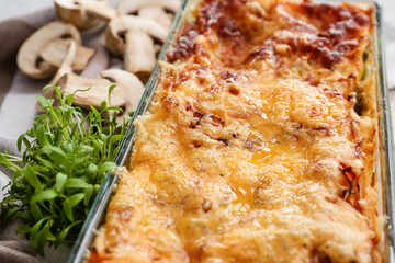 Baking dish with tasty vegetable lasagna on table, closeup