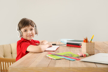 Little boy studying online at home