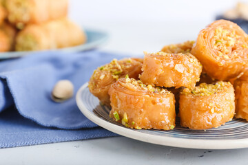 Plate with delicious baklava on light background, closeup