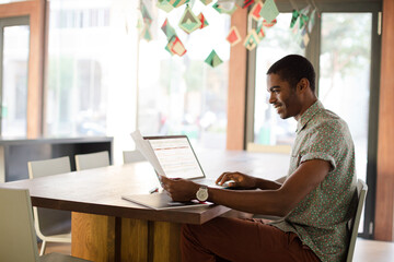 Man working on laptop at office
