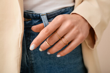 Fashionable young woman with beautiful manicure and stylish jewelry, closeup