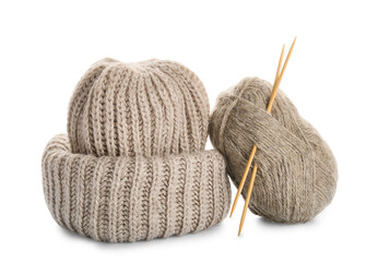 Yarn with knitting needles and hat on white background