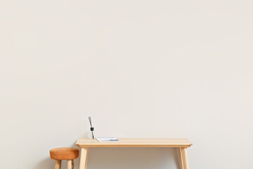 TV stand with reed diffuser and chair near light wall