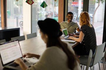 People working at conference table in office