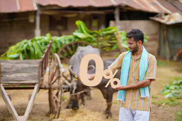 Banking or financial concept : Young indian farmer showing zero percent symbol at his cattle farm