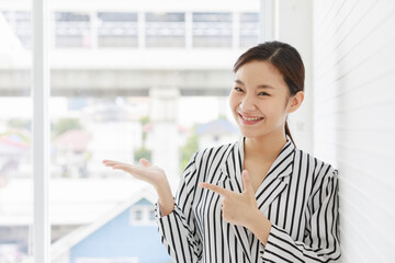 Portrait shot of Asian young successful pretty female businesswoman wears white black stripe formal...