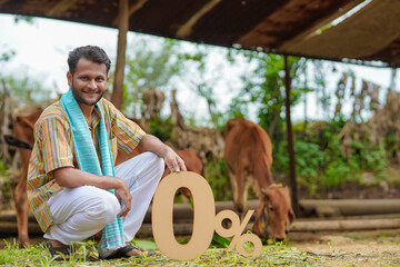 Banking or financial concept : Young indian farmer showing zero percent symbol at his cattle farm