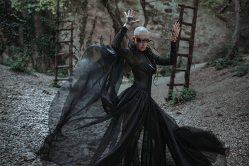 Fototapeta premium Mysterious ghost bald woman in a black long dress.