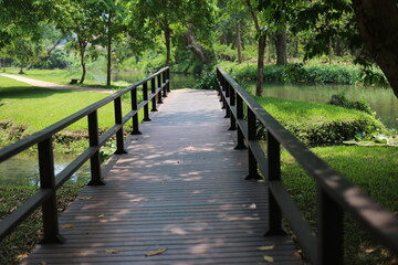 Fototapeta na wymiar Photo of wooden bridge in park