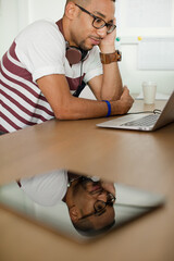 Man‚Äö√Ñ√¥s face reflected in digital tablet