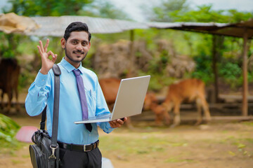 Technology concept : Young indian agronomist or banker using laptop.