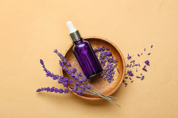 Bowl with bottle of lavender essential oil and flowers on color background - obrazy, fototapety, plakaty