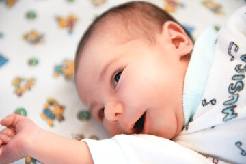 A newborn charming baby yawns. Close-up.