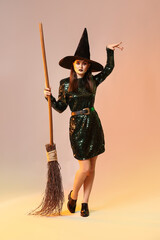 Beautiful woman dressed as witch for Halloween on color background